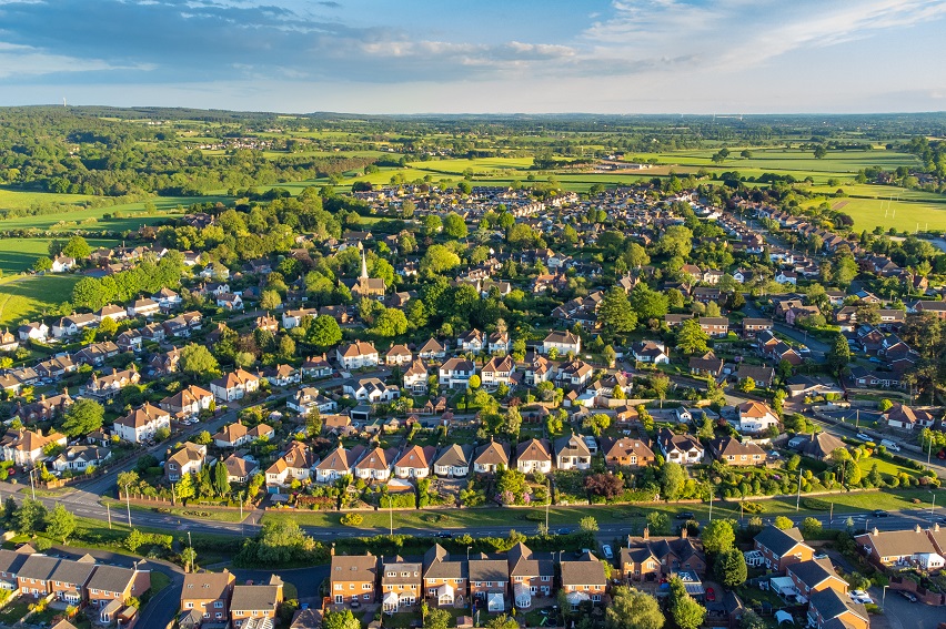 Photo of houses surrounded by fields