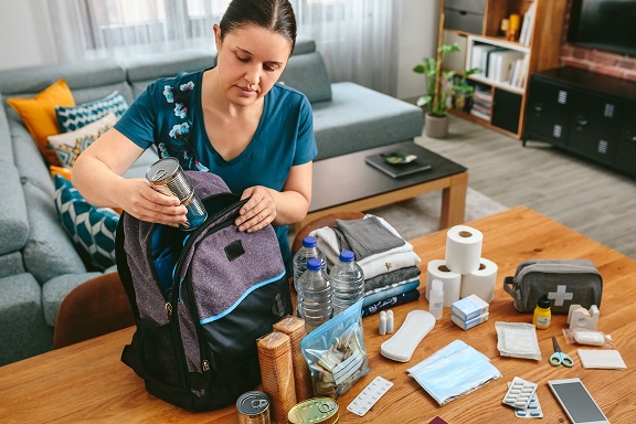 Photo of someone preparing a back pack of essential items