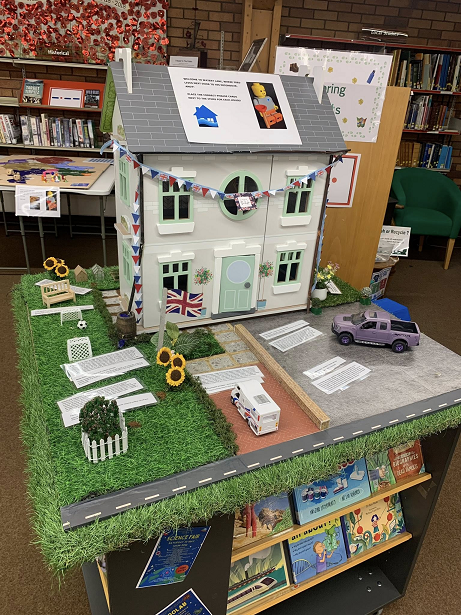Table top display of a model house with information about the FAIR project