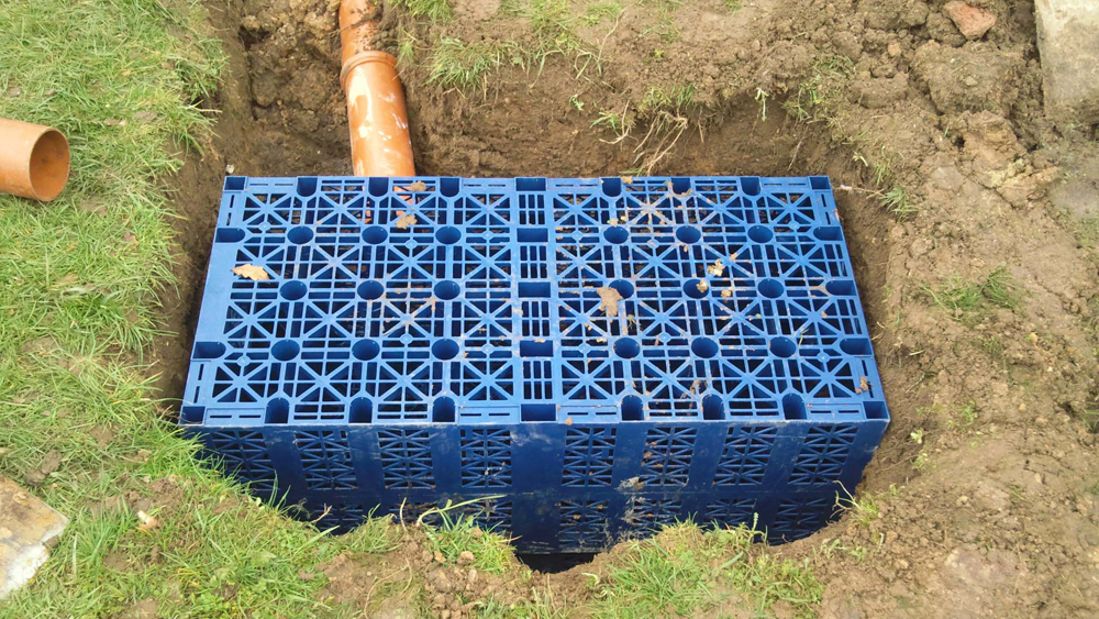 Closeup of a small soak away dug into the ground