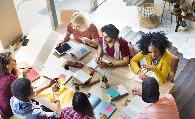 Photo of people collaborating round a table