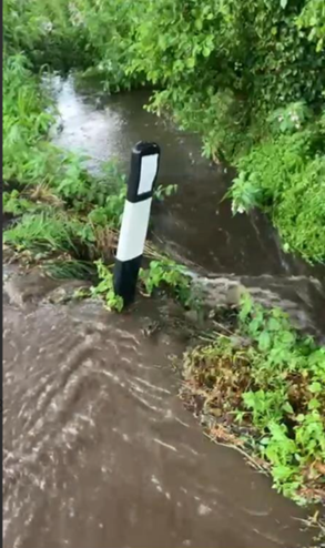 Image showing water flowing outside channel bounds and onto road